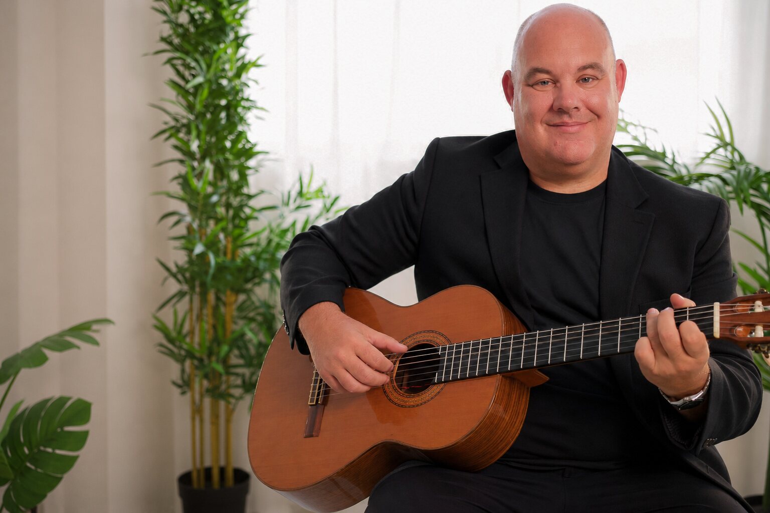 Stuart Toogood, celebration of life guitarist, playing acoustic guitar